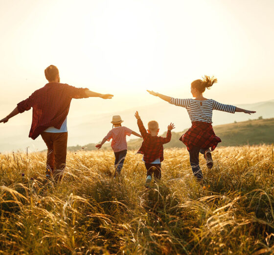 Happy family: mother, father, children son and daughter on sunset