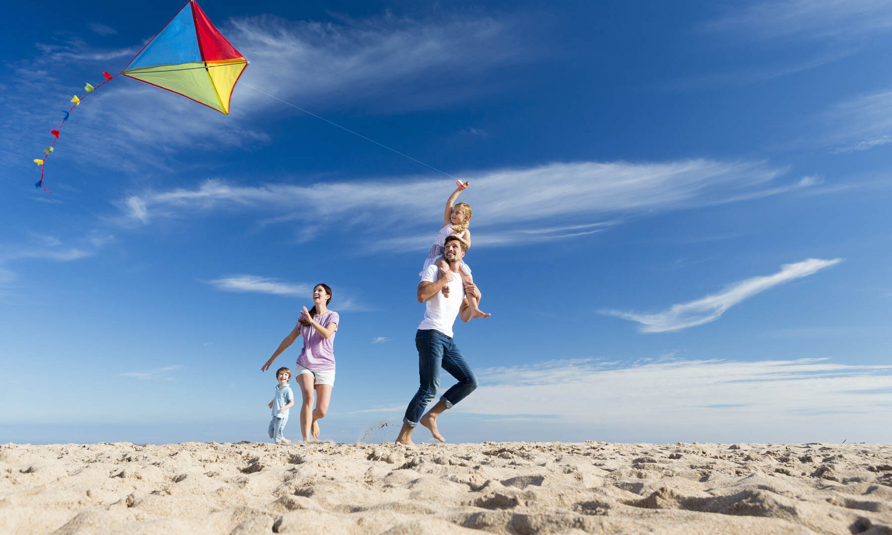 Family on the Beach Flting a Kite